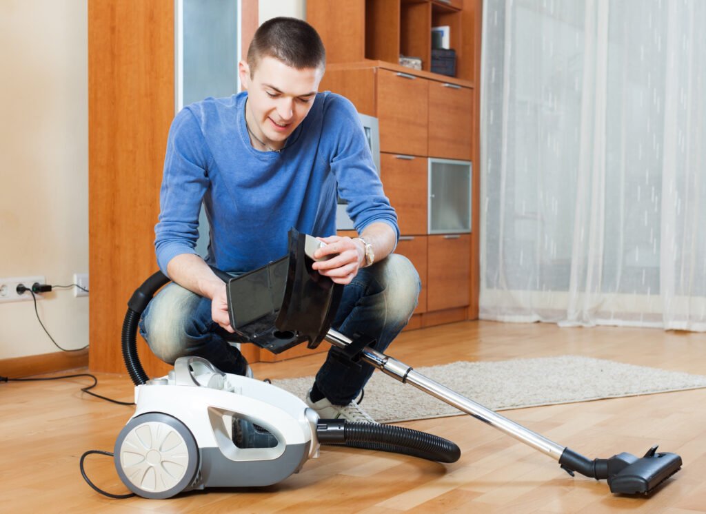 vacuum cleaner; cheerful; clean; cleaner; cleaning; domestic; dust; equipment; man; guy; male; holding; home; house; household; housekeeping; housework; interior; one; people; person; room; vacuum; vacuum-cleaner; vacuuming; chores; chore; cleans; indoor; portrait; small; smiling;